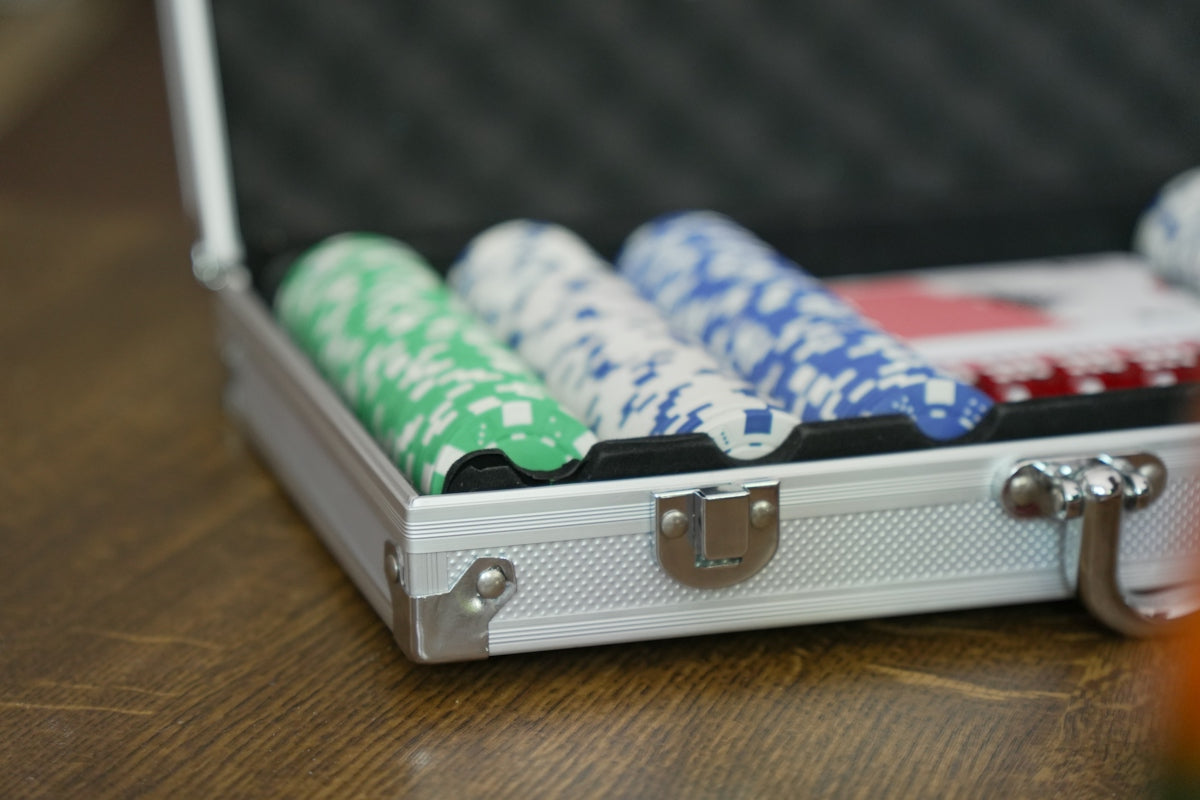 Poker chips in an open silver case.
