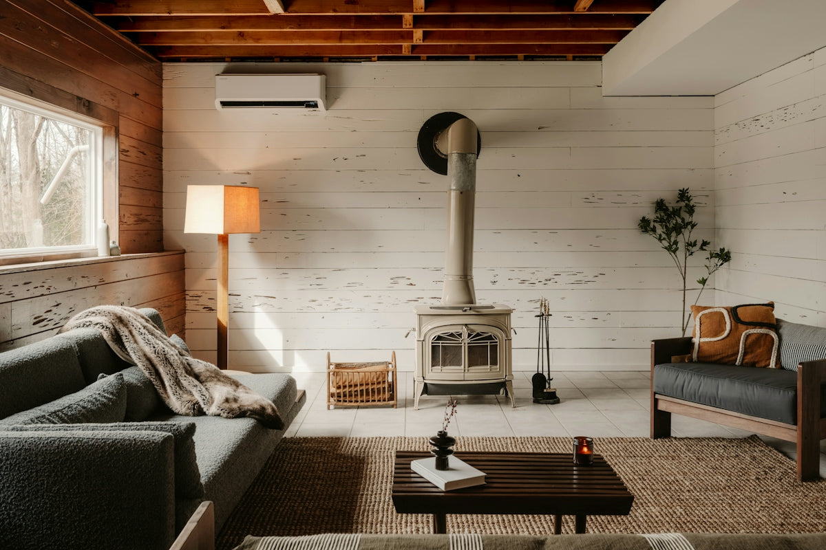 Cozy living room with wood stove and sofa